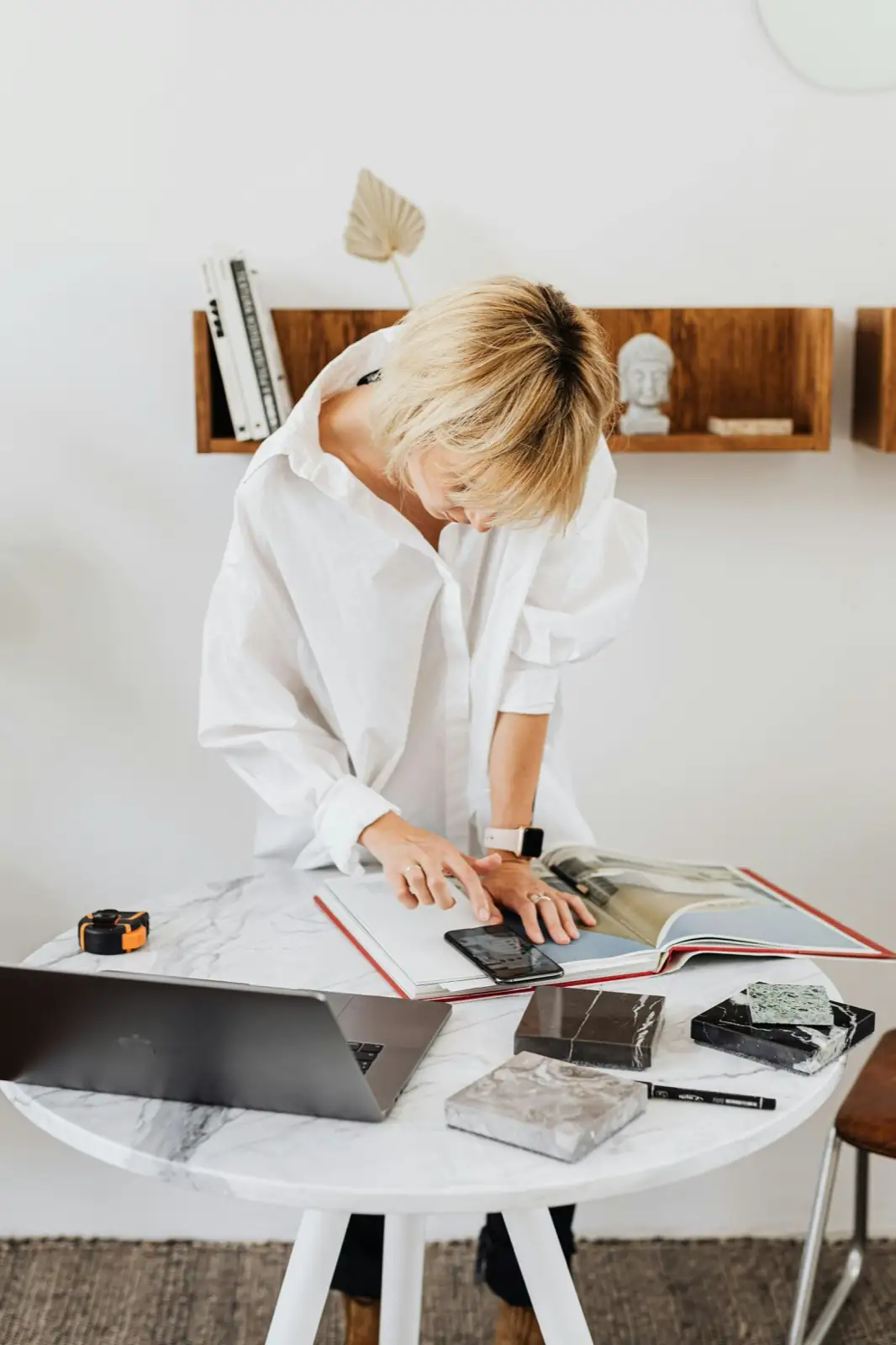 A designer developing a staging plan with material samples